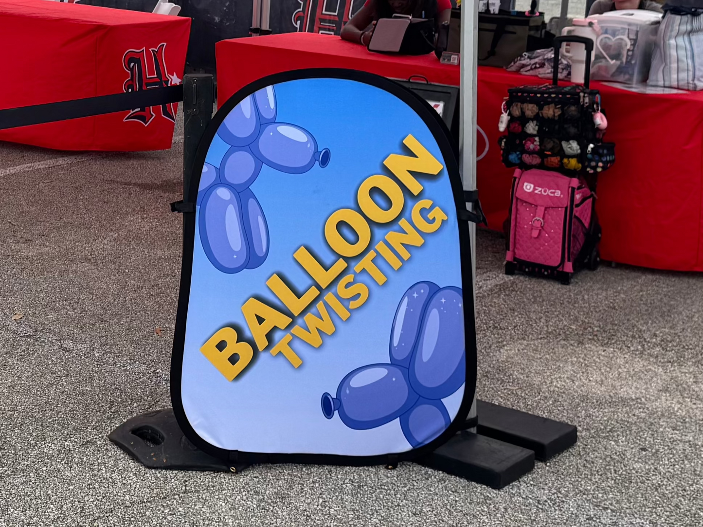 Pop up balloon twisting sign in use on the job