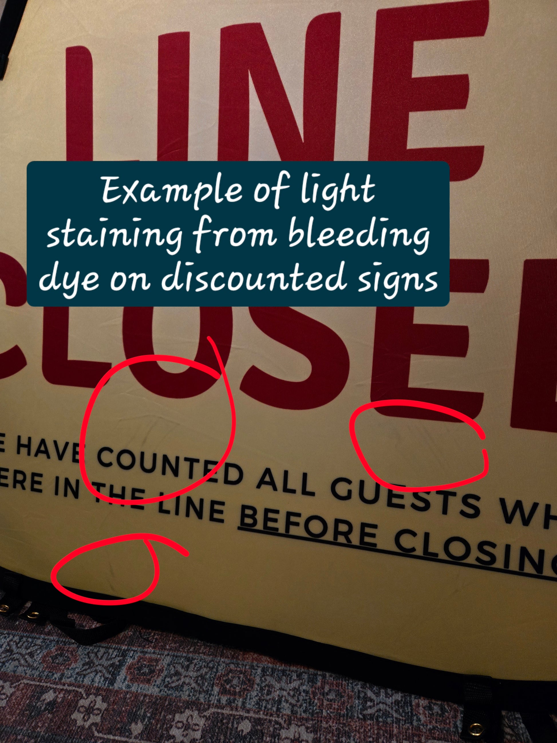 Discounted sign with light staining from bleeding dye, circled for emphasis.